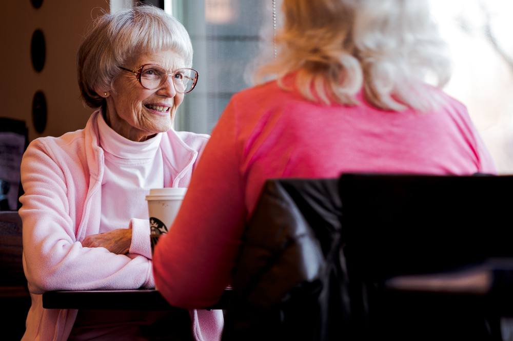 Two women sharing a warm conversation over coffee